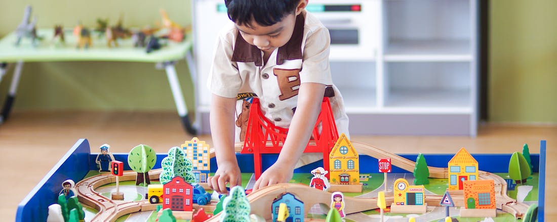 Boy playing with wooden toys