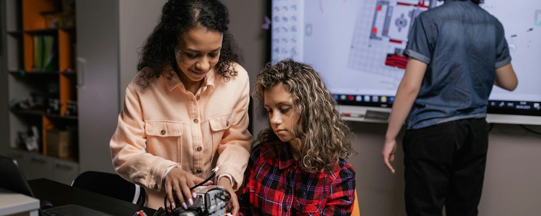 Teacher and student in a STEM lab by Alena Darmel