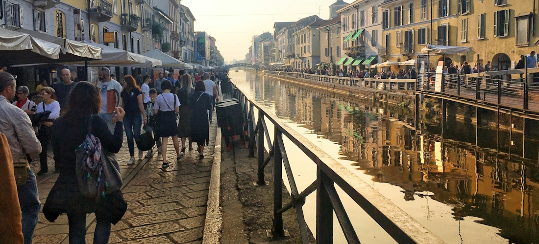 Busy walkway on the side of a canal