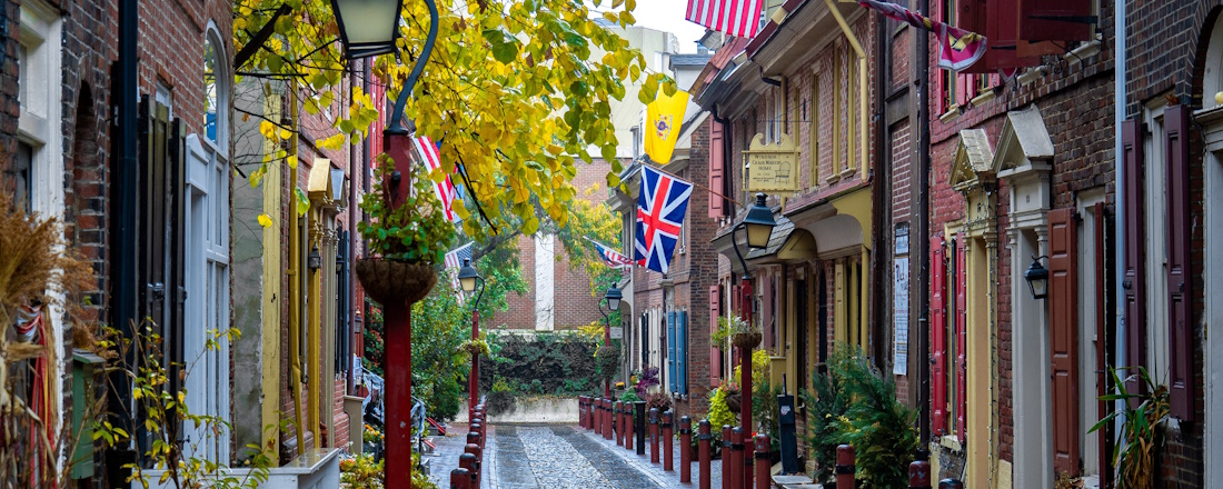 a narrow Philly street with flags on the side