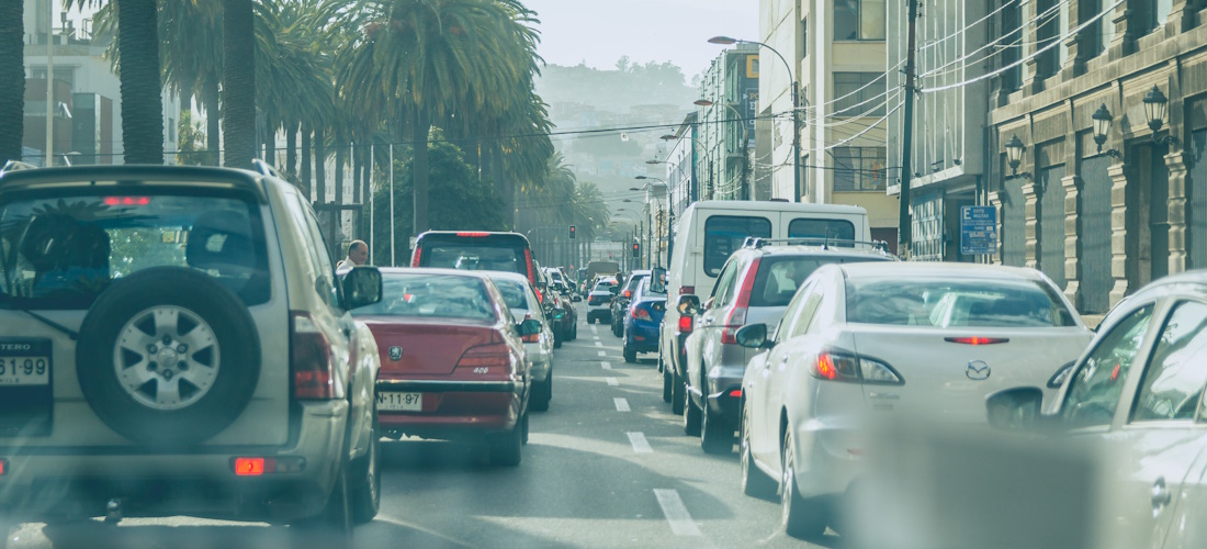 View down the middle of two lanes of bumper-to-bumper traffic in Santiago