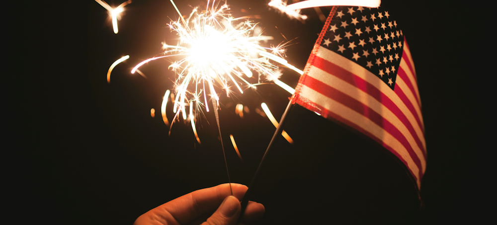 Sparkler and American Flag by Stephanie McCabe on Unsplash