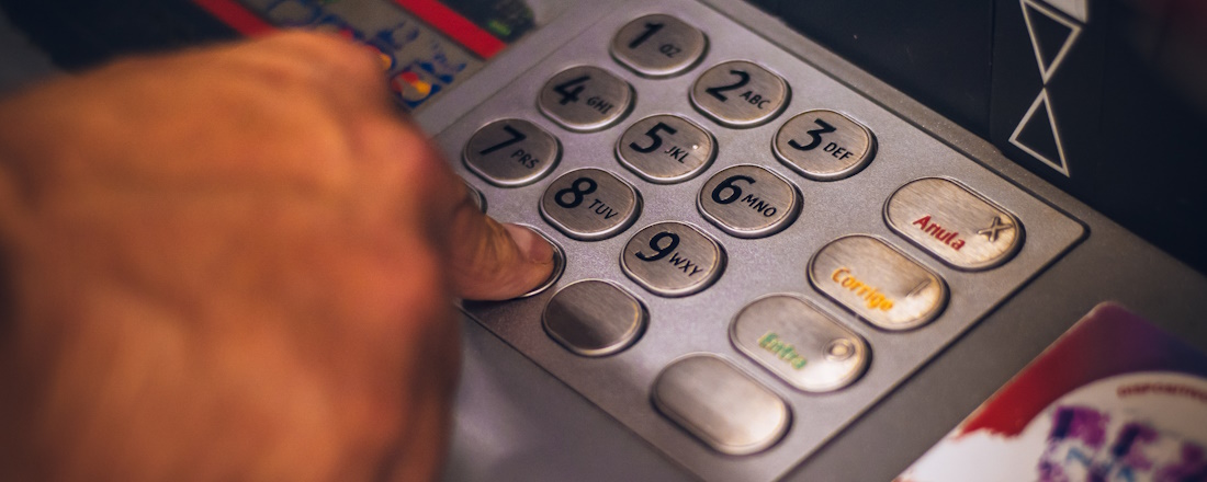 Stock image of person typing on ATM keypad