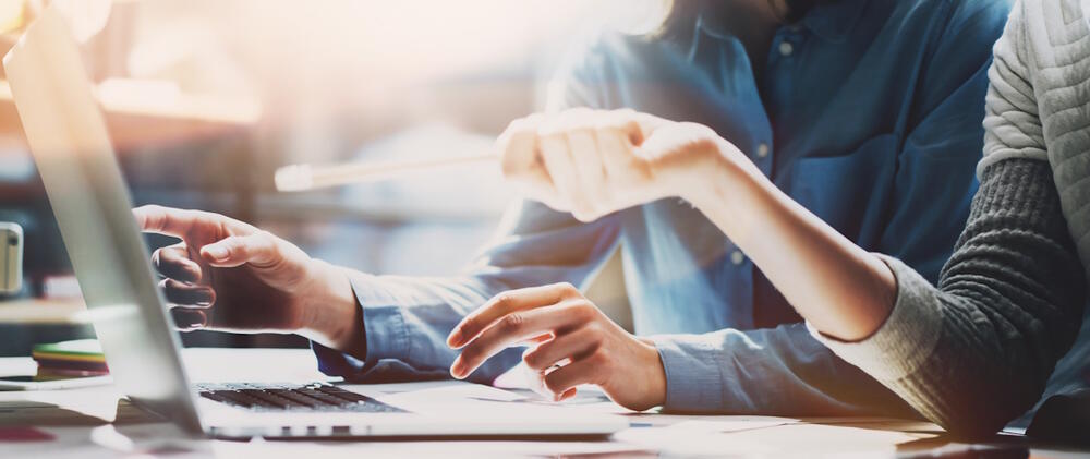 stock image of two people collaborating