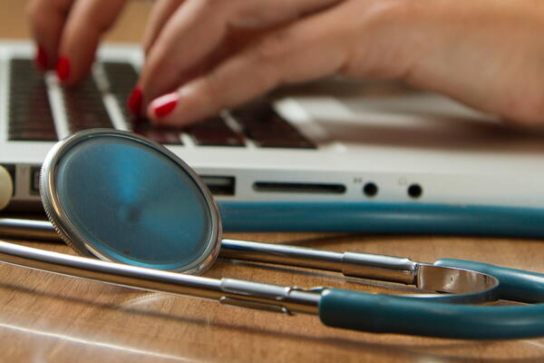 stethoscope next to laptop