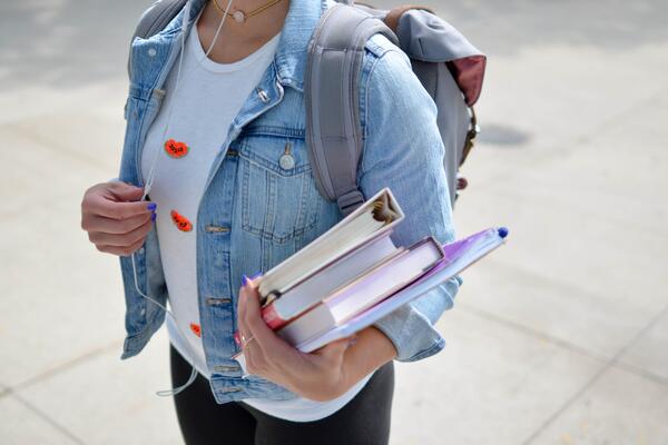 Young woman holding textbooks