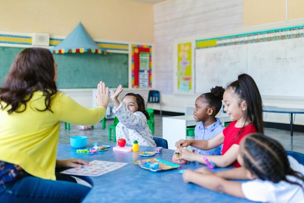 Kids playing with teacher by RDNE Stock Project