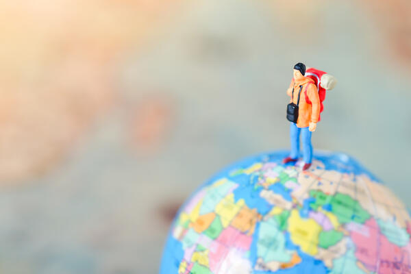 travel figurine on globe