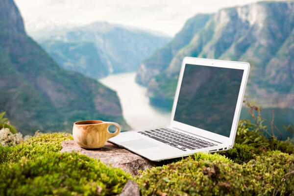 laptop and coffee mug in an exotic location