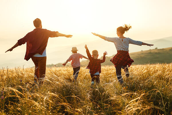 Family jumping in sunlight